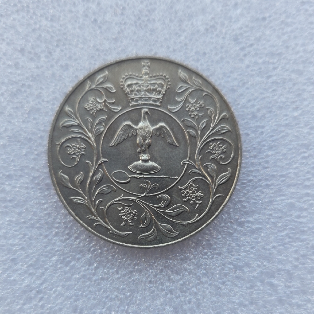 Intricate Silver Coin with Crown and Eagle